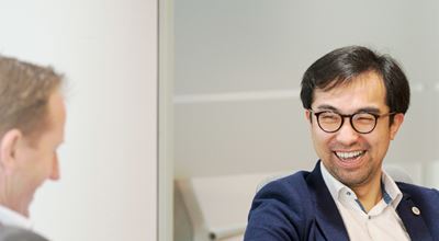 Two employees laughing at each other at the office