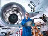 Production of aircraft. Worker standing in front of the aircraft engine. Thanks to high temperature tolerance, Levasil colloidal silica is perfect as a binder in precision investment casting used when making the blades for a turbo-jet engine.