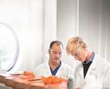 Two Nouryon employees at work with lab coat and safety glasses