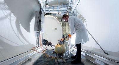 Nouryon employee in lab coat doing an experiment