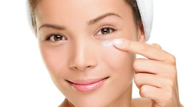 Woman applying facecream 