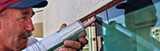 man applying sealant on buiding's window