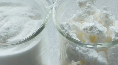 Two product samples in beakers with Expancel expanded thermoplastic microspheres lightweight fillers, with extremely low density. 